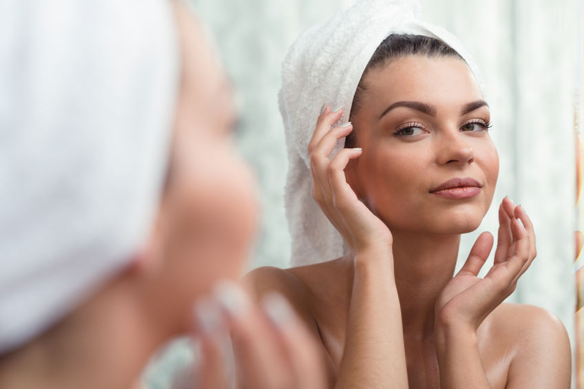 woman exfoliating face